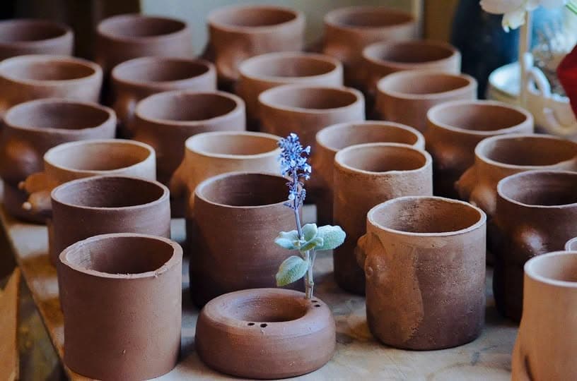 Cups drying in rows before the first firing