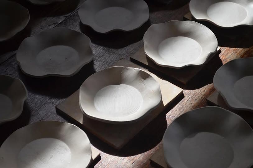 Scalloped plates waiting to be fired
